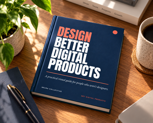 Design Check with Design Better Digital Products book resting on a sunlit wooden desk beside a plant, coffee cup, notebook, and pen.